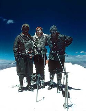 Monica Jackson and two sherpas, on a mountain, in goggles and sunscreen.
